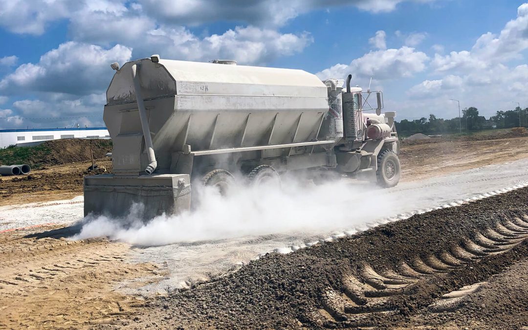 A spreader truck spreads product over the problematic soil