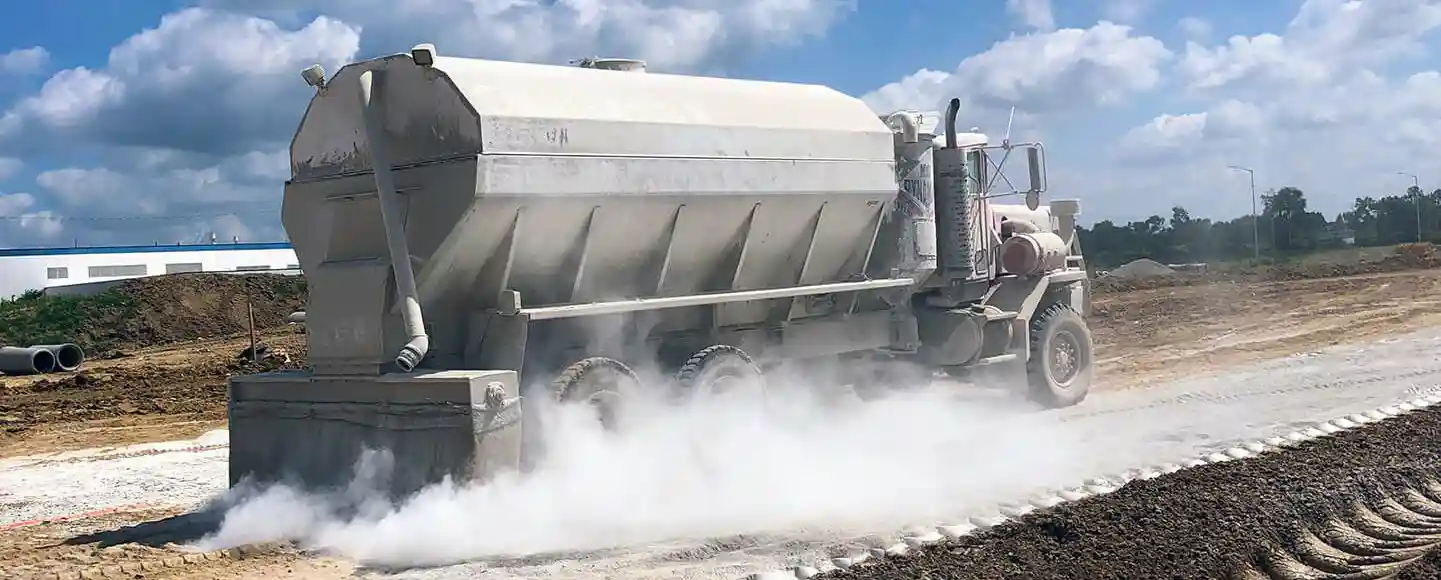 A spreader truck spreads product over the problematic soil