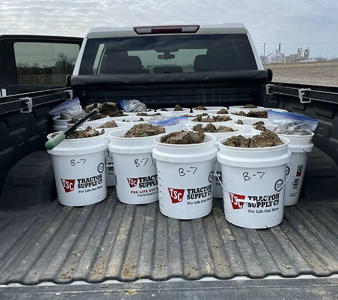 Truck with multiple buckets full of samples from different areas of a project site.